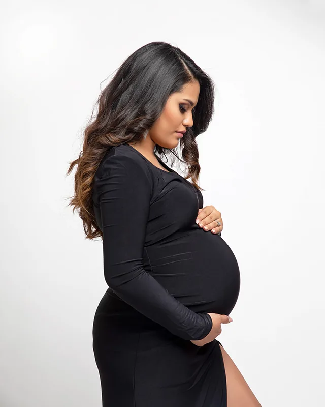 Tampa maternity portraits expectant mother looking down at belly